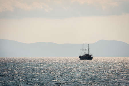 Sailing sea in the seascape on the background of silhouette of mountainsの写真素材