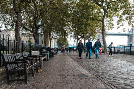 London, United Kingdom - October 20, 2016: People are walking on the coast of river Thames near the Tower of London in London, Englandのeditorial素材