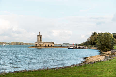 Rutland Water Park, England - October 22, 2016: People are getting off the boat in Rutland water near the Normanton Church which is Rutland's most famous landmark. England, United Kingdomのeditorial素材