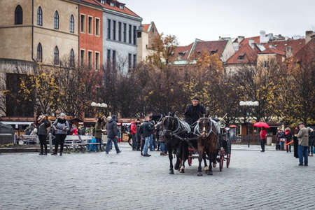 Prague, Czech Republic- November 12, 2017: Coachman of the horse carriage is offering rides for tourists in the Old Town square of Prague, Czech Republicのeditorial素材