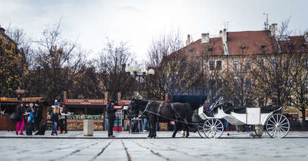 Prague, Czech Republic- November 12, 2017: People are walking in Prague Town square next to the horse carriage in an autumn dayのeditorial素材
