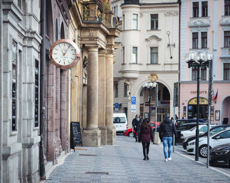 Prague, Czech Republic- November 12, 2017: People are walking on the street and passing by the clock in the centre of Prague, Czech Republicのeditorial素材