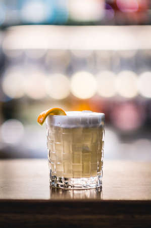 Alcohol cocktail in the glass with berries on the bokeh background.の写真素材