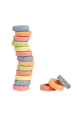 Pile of multicolored vitamin candies isolated on whiteの写真素材