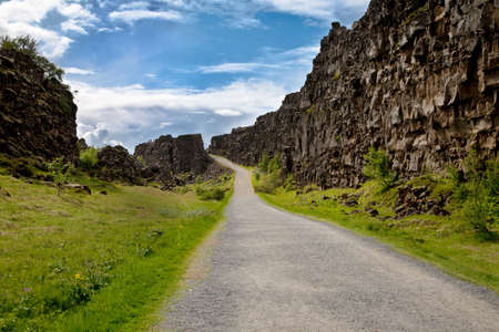 Path along fissure Almannagja at Thingvellir National Park in Iceland where the european and american continental plates drift apartの写真素材