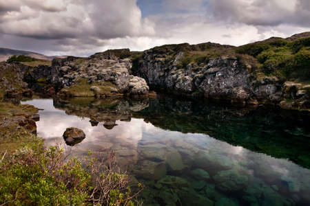 Deep fissure Flosagja with crystal clear cold water at Thingvellir National Park  The fissure in the earthの写真素材
