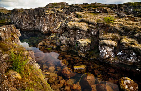 Deep fissure Flosagja with crystal clear cold water at Thingvellir National Park  The fissure in the earthの写真素材