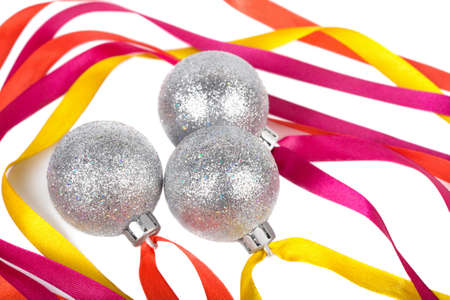 Three christmas silver balls with ribbons isolated on white background