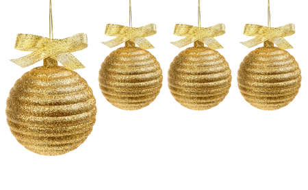 Four golden christmas balls with golden ribbon isolated on whiteの写真素材