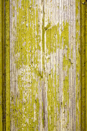 Old wooden board with flaked green paintの写真素材