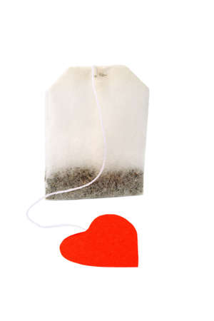 Tea bag with heart-shaped red label isolated on whiteの写真素材