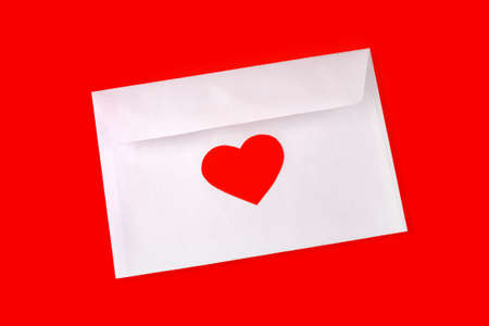 Envelop with red heart on red backgroundの写真素材