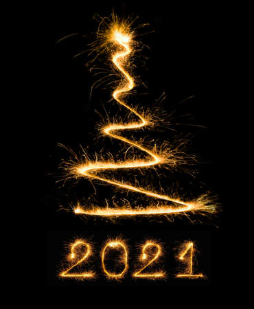 Christmas tree and numbers 2021 made by sparklers Bengal lights on black background for design...