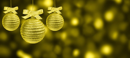 Three christmas balls over abstract background of defocused holiday bokeh. Greeting banner of trendy colors of the year 2021の写真素材