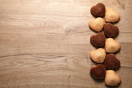 Heart shaped cookies on wooden background. Baked butter and chocolate cookies, empty space for text. Valentines Dayの写真素材