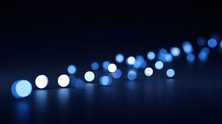 Captivating abstract image featuring blue bokeh lights on a dark background, creating a serene and imaginative atmosphere suitable for various creative projects.の素材