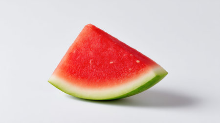 A captivating image of a fresh watermelon slice showcasing its bright red flesh and green rind, ideal for summer promotions, healthy recipes, and vibrant food presentations.の素材