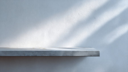 A striking concrete shelf against a subtle blue wall, illuminated by soft light, offering a modern touch ideal for interior design, home spaces, and minimalist aesthetics.の素材