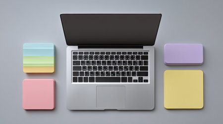 A sleek laptop sits at the center, surrounded by vibrant sticky notes. This setup promotes creativity and organization, perfect for any professional or student.の素材