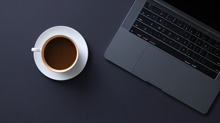 A sleek laptop sits next to a steaming cup of coffee on a dark table, perfect for showcasing productivity, creativity, and modern work environments in design projects.の素材