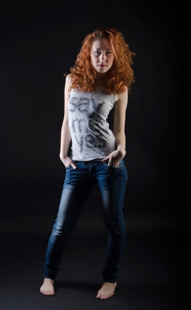 Red-haired beauty portrait against black backgroundの写真素材