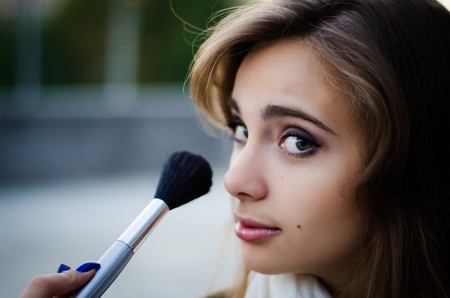 Girl with makeup brush close up shotの写真素材