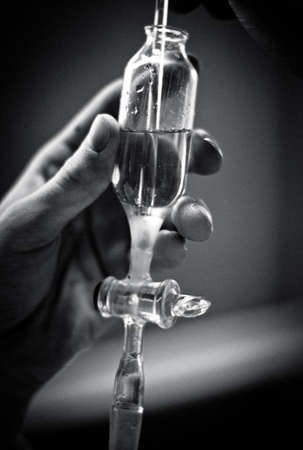 Chemical funnel with heavy liquid  Black and white close up 