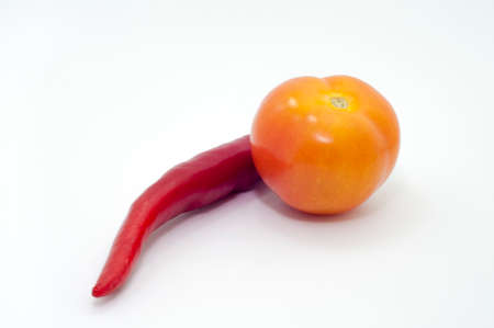 the selective focus of tomato and chili over white background. healthy diet conceptの写真素材