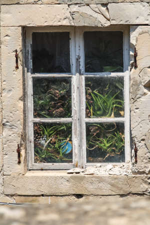 old window on a stone wall in dubrovnik croatiaの写真素材
