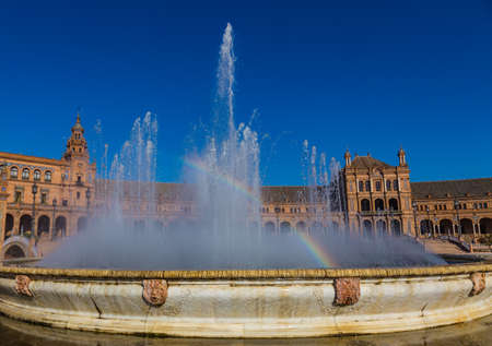 Rainbow in the fountain in the Plaza of Spain in Seville.の写真素材