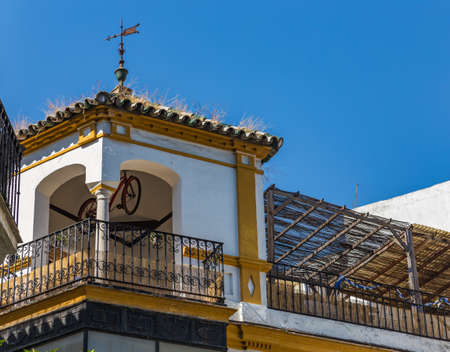 Terrace and gazebo with a hanging bike on the roof of a house in Seville, Spain.の写真素材