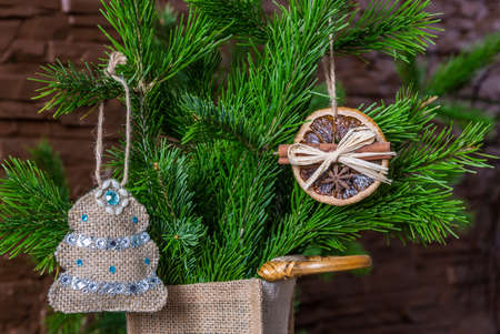 Christmas composition of dry orange slices and cinnamon sticks and a Christmas tree on a branchの写真素材