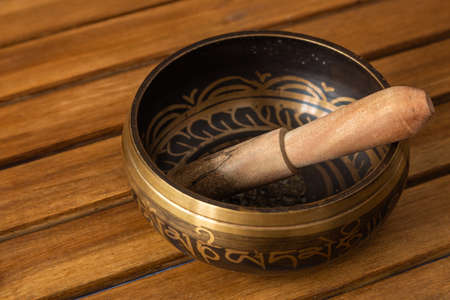 Tibetan singing bowl on a wooden stand