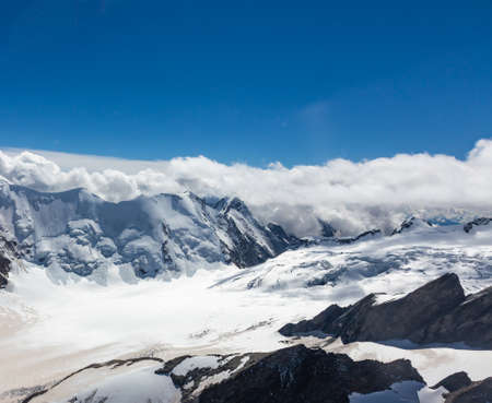 Helicopter walk over the Swiss Alps in the town of Interlaken. View of the mountains, clouds, snow...