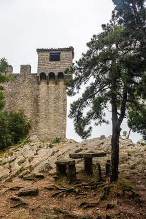 Watchtower on the wall surrounding Guaita Fortress in San Marino in the fogの写真素材