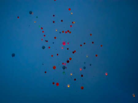 Bright colorful balloons fly into the evening sky in Altaiの写真素材