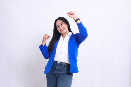 gesture of beautiful mature office woman wearing a formal blue suit standing right cheerful both hands clasped up and down sign of success, success, perfection. for company, beauty, business, financeの写真素材