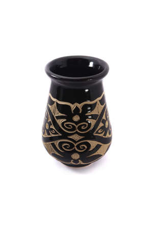 A black vase made from clay with beutiful sculpture isolated on white backgroundの写真素材