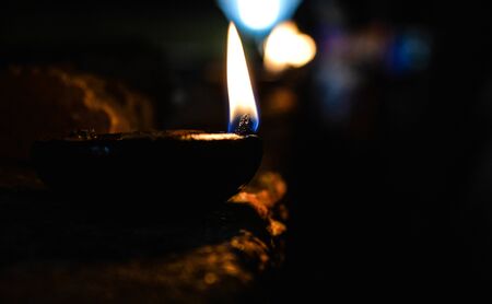 Lamp with oil during a festival. Flame from a lamp during Deepam festival celebrated in South India.のeditorial素材