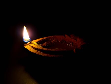 An oil lamp lit as an offering to hindu for worship with selective focus.の写真素材