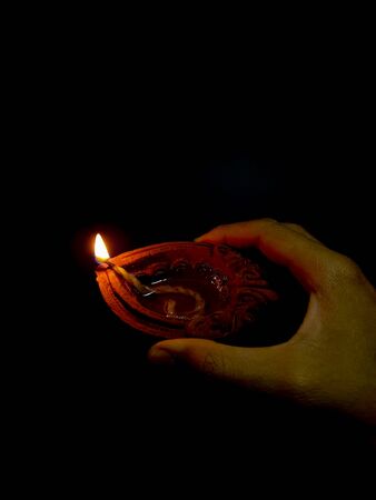 An oil lamp lit as an offering to hindu for worship with selective focus.の写真素材
