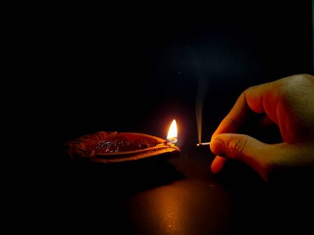 An oil lamp lit as an offering to hindu for worship with selective focus.の写真素材
