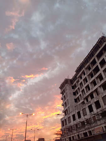 Under construction building site with blue yellow skyの写真素材