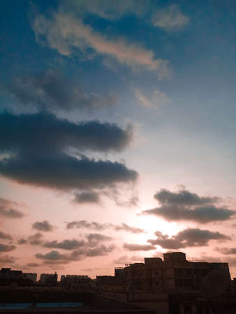 Beautiful multicolored sunset over a dark cityscape.の写真素材
