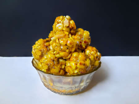 Sweet peanut balls made with roasted peanuts and jaggery on black and white backgroundの写真素材