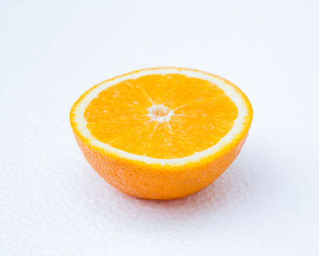 Half orange fruit on white background, fresh and juicyの写真素材