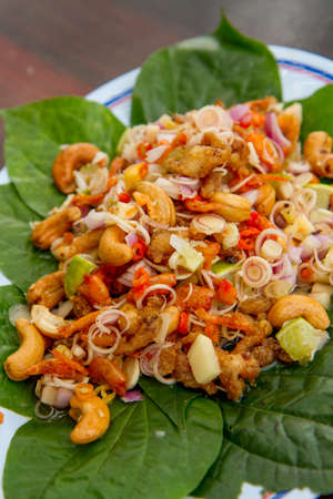 Herb salad with deep fried fish and lemongrass. Thai food.の写真素材