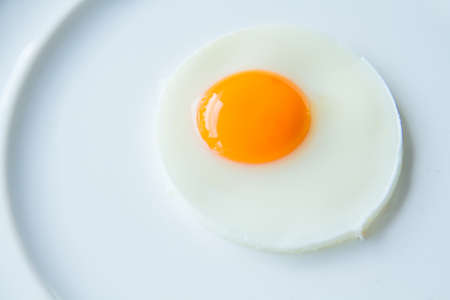 a fried egg on white dishの写真素材