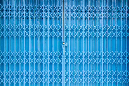 Antique slide steel locked shutter door texture backgroundの写真素材