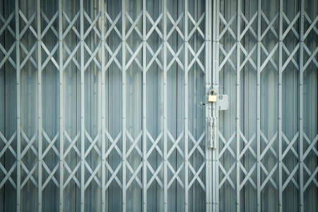 Antique slide steel locked shutter door texture backgroundの写真素材